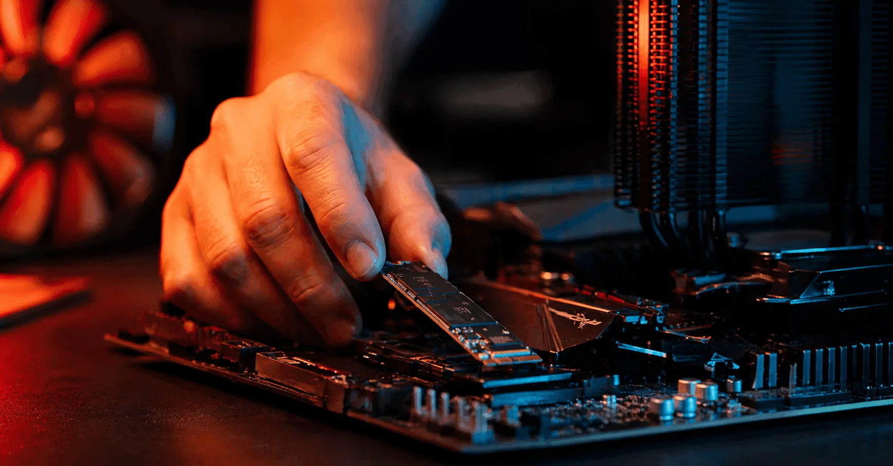 Hand installing a 4TB NVMe M.2 SSD into a custom gaming PC motherboard